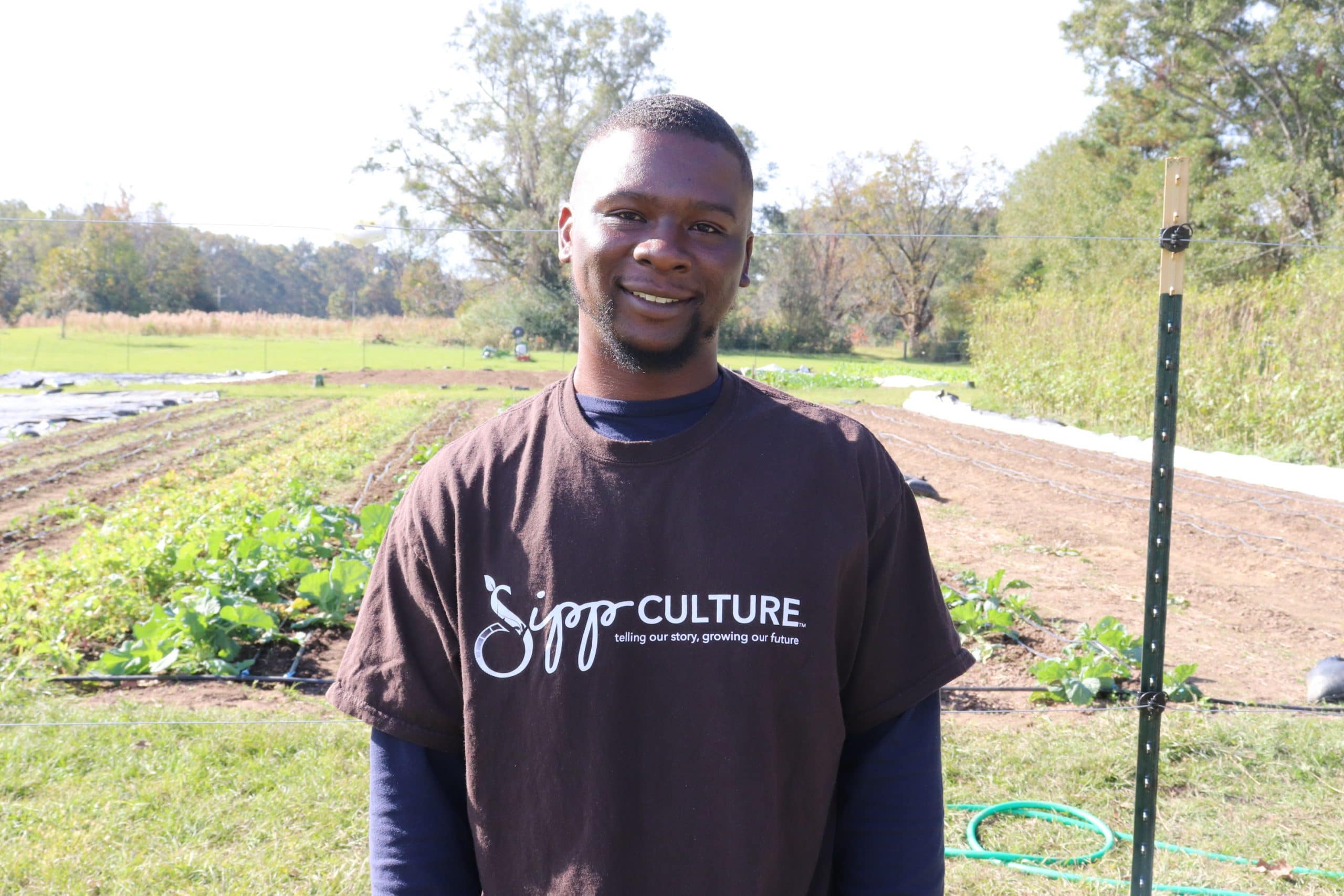 Young Black Man at Community Farm Smiling