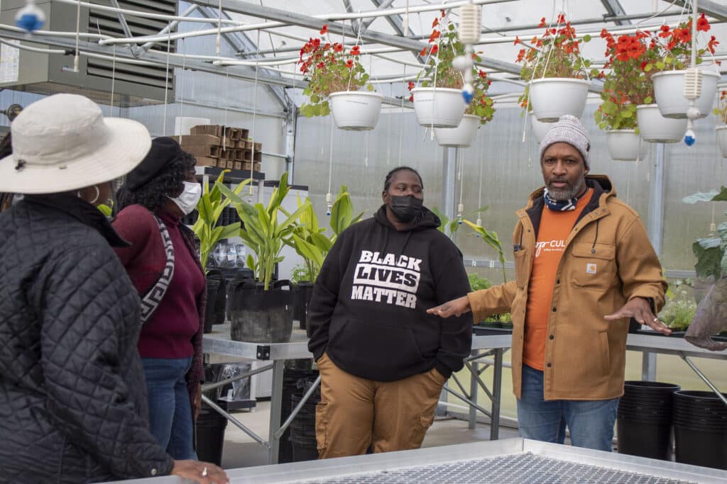 Co-director Carlton Turner giving a tour of the Sipp Culture Community Farm greenhouse to members of the Southern Rural Black Women in Agriculture (SRBWIA). photo by Allison Allen